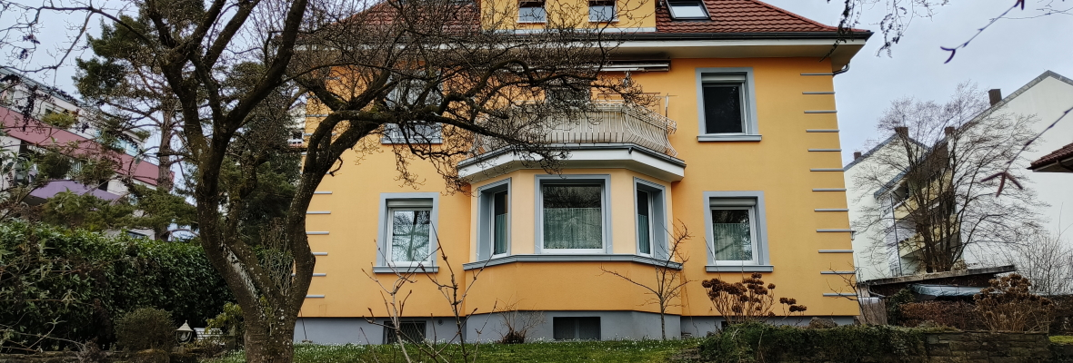 Gelbes Haus auf einem Grundstück.